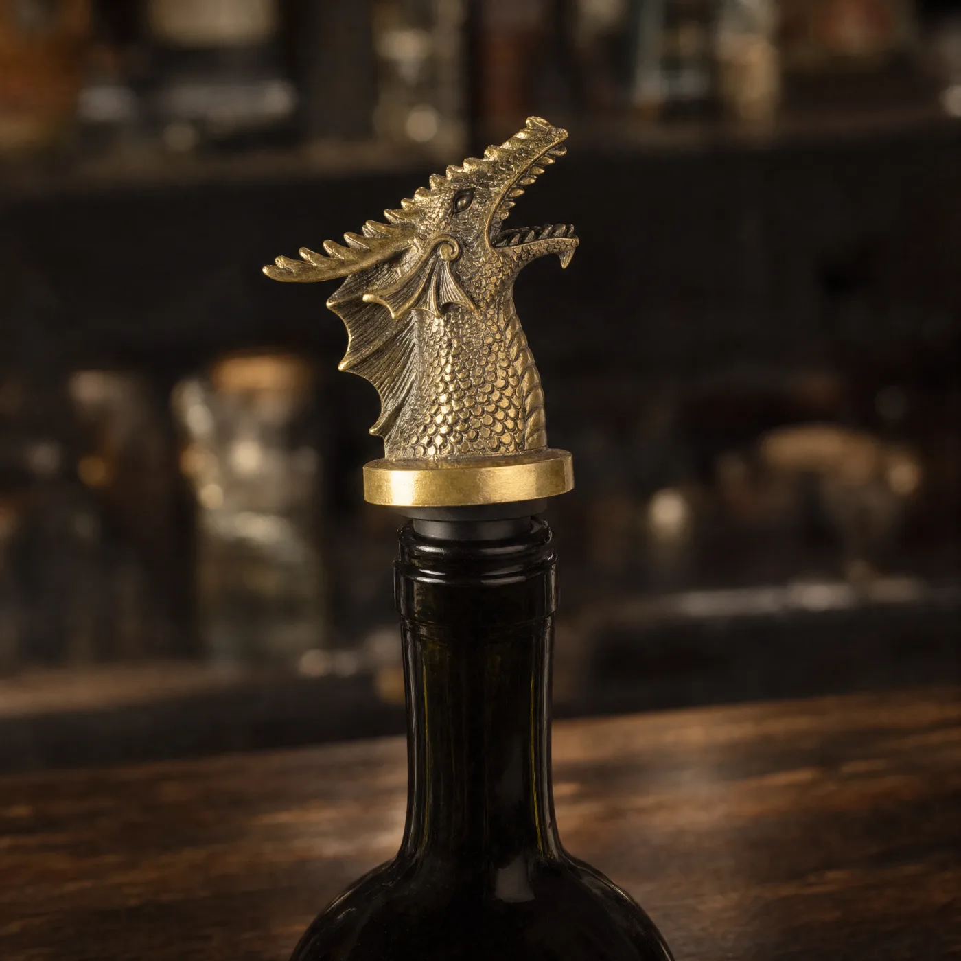 Bronze dragon-head bottle pourer fitted in a dark bottle on a bar counter