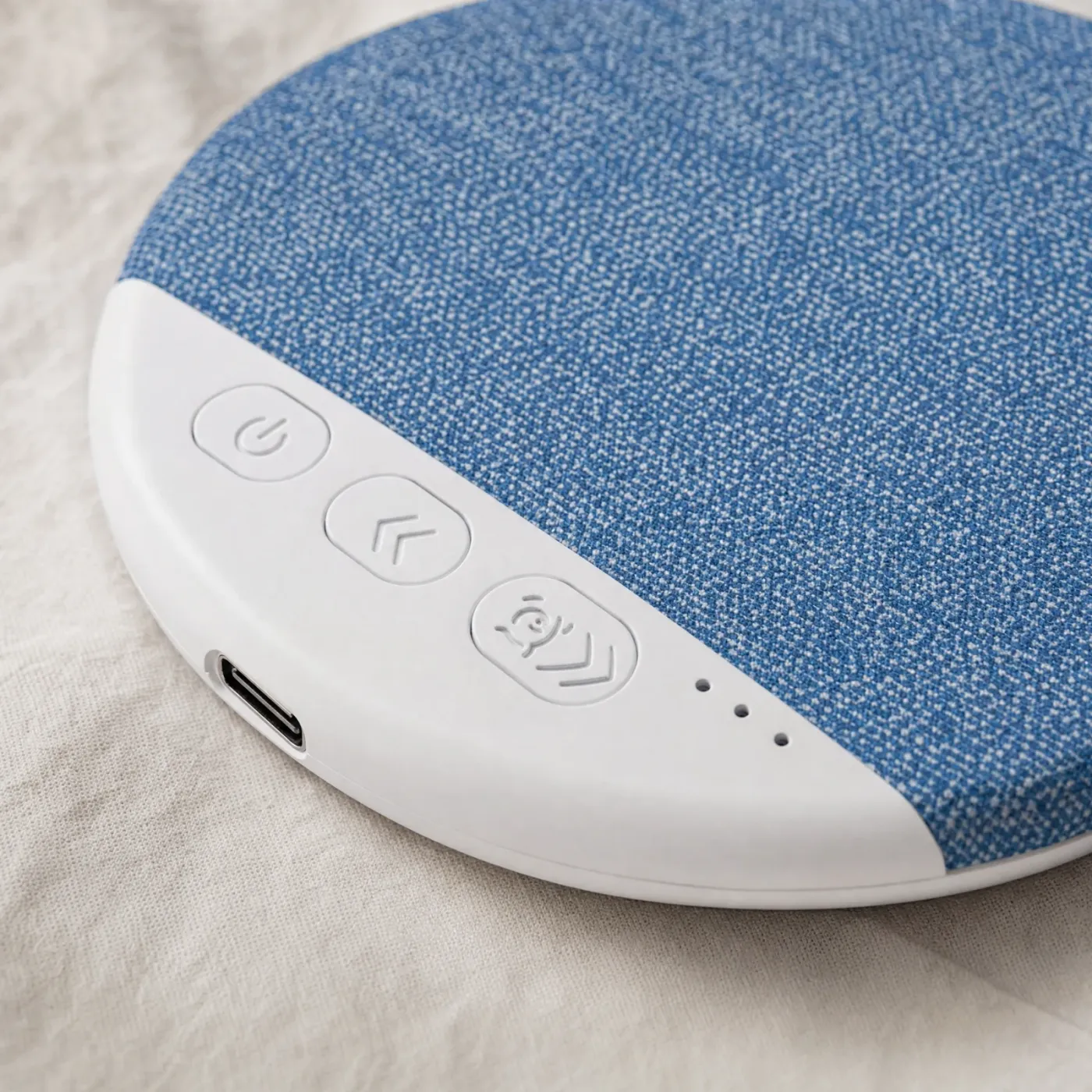 Close-up of the speaker's white edge: power, back and white-noise buttons, three small lights and the USB-C port