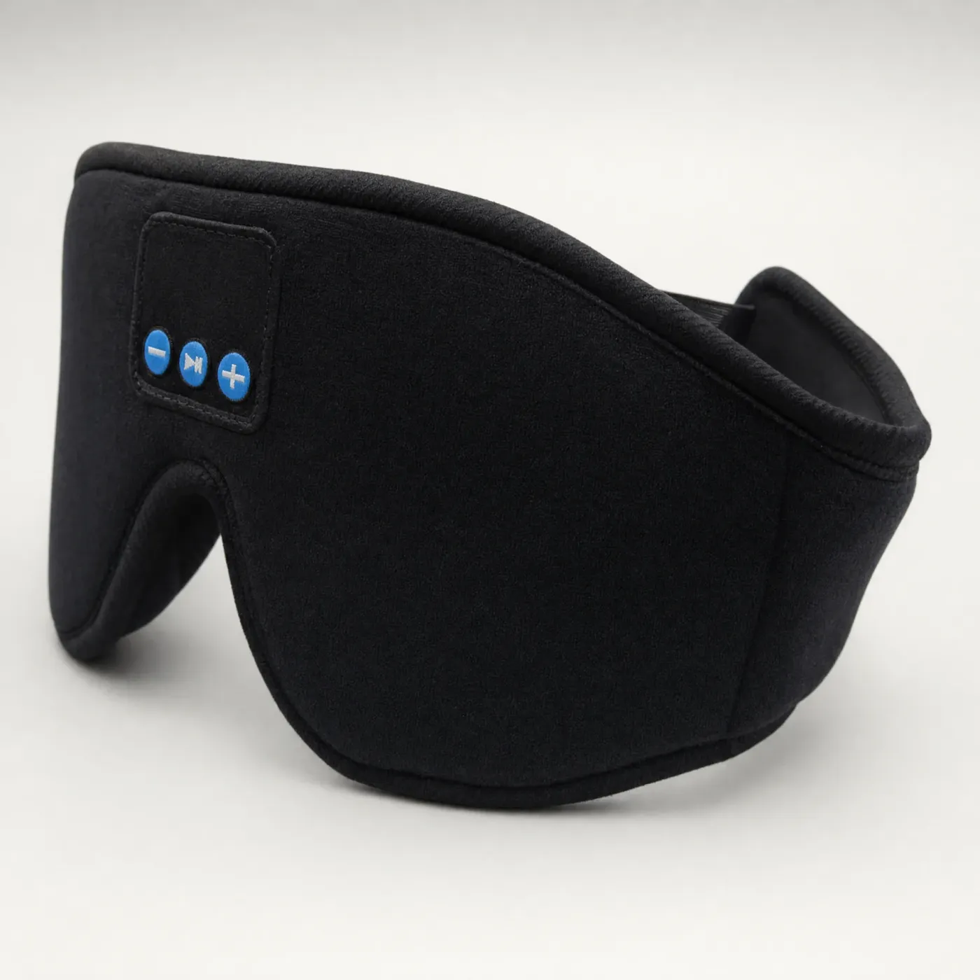 Black Bluetooth sleep mask, three-quarter view on a light grey background
